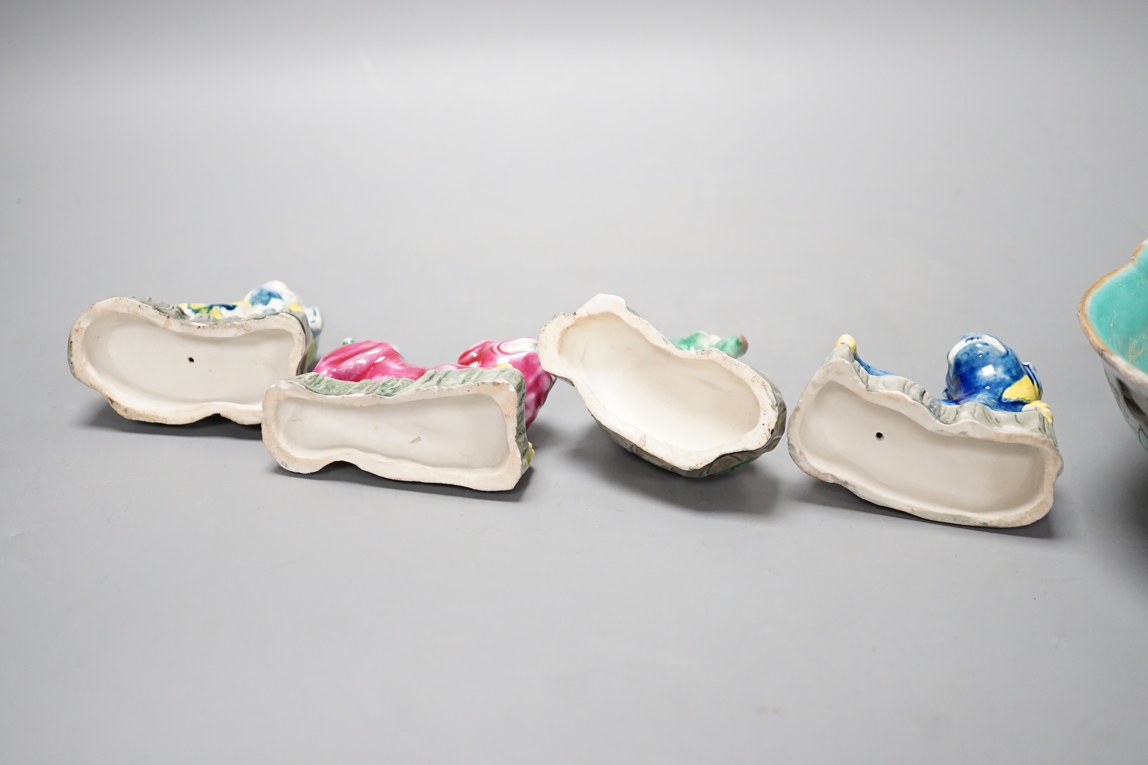 Four Chinese polychrome glazed models of lion-dogs, Republic period and a Chinese famille rose dish, Tongzhi mark, 15.5cm (5)